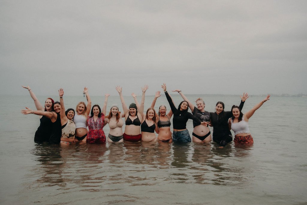 Women celebrating together in the ocean