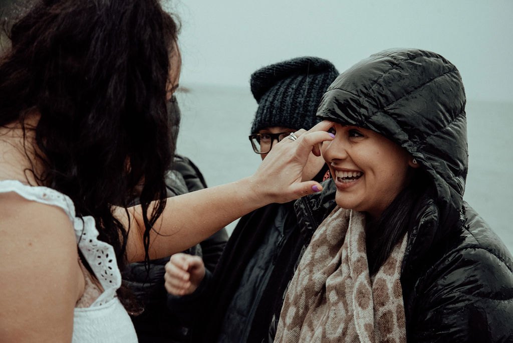 A woman smiling during a beach ritual